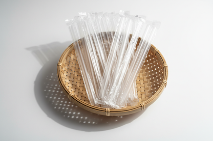 Individually wrapped clear bubble tea straws in basket